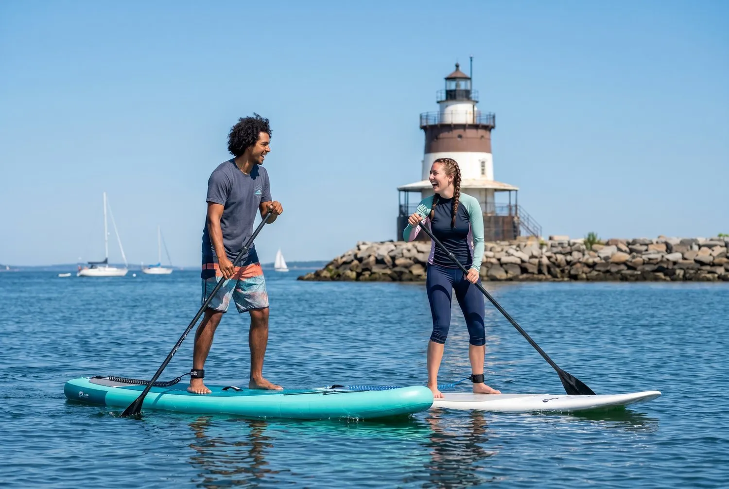 Paddleboarders near Spring Point Ledge Lighthouse in South Portland, Maine Paddleboarders near Spring Point Ledge Lighthouse in South Portland, Maine