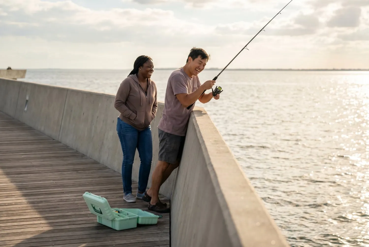 Two friends fishing from the St. Pete Pier over Tampa Bay in St. Petersburg, Florida Two friends fishing from the St. Pete Pier over Tampa Bay in St. Petersburg, Florida