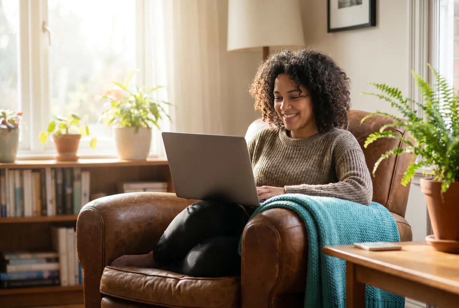 An adult in a comfortable armchair during an online psychiatry video visit at home An adult in a comfortable armchair during an online psychiatry video visit at home