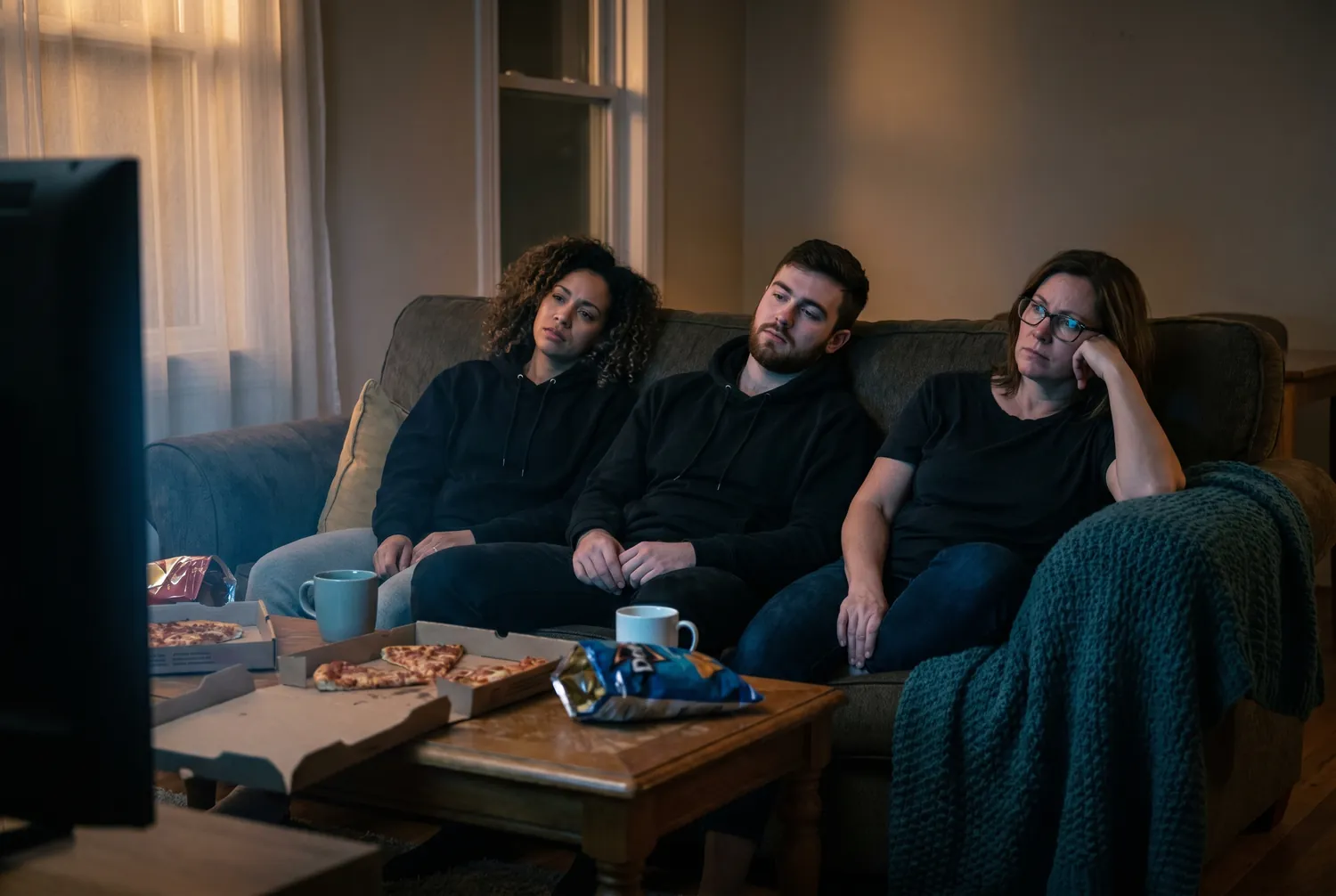Three disappointed friends on a couch reacting to their team losing the big game Three disappointed friends on a couch reacting to their team losing the big game