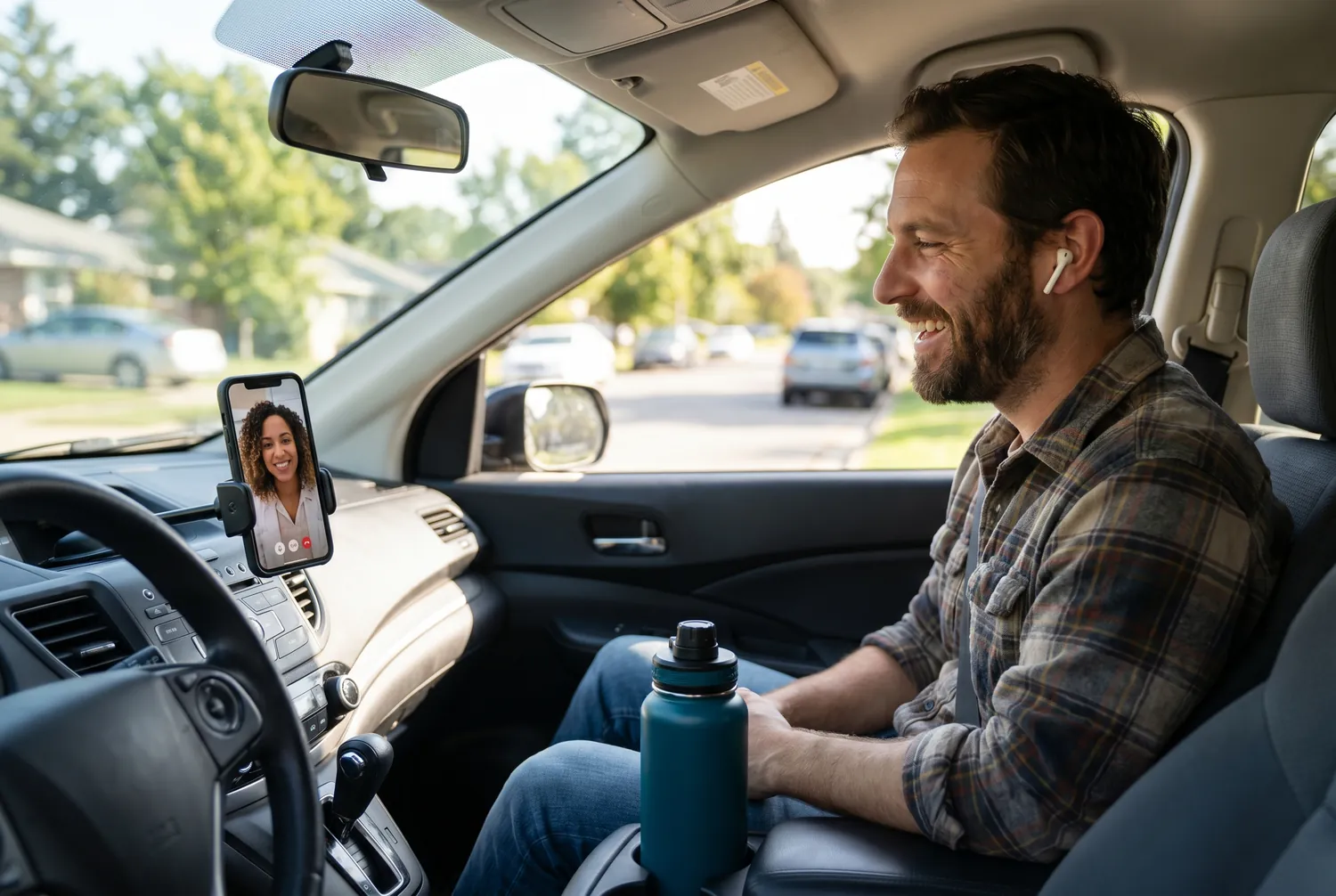A man in a parked car having a private telepsychiatry video visit on his phone A man in a parked car having a private telepsychiatry video visit on his phone